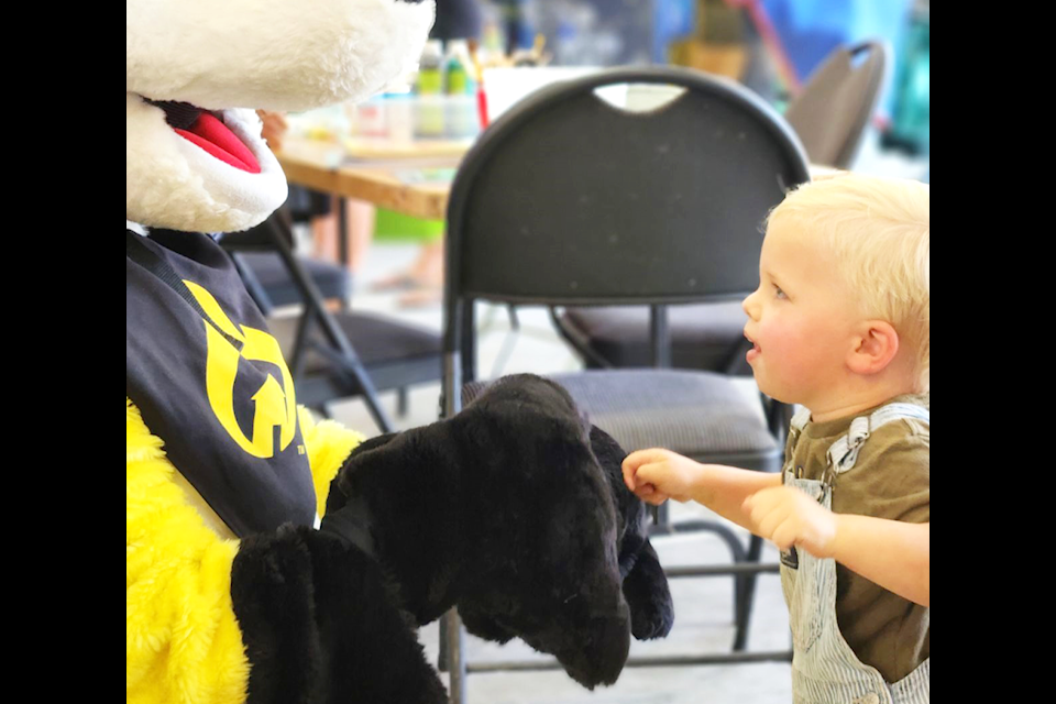  After a little bit of play boxing, Levi Goosen moved in for a hug from Ember, the FireSmart mascot, who entertained visitors at the Community Day on Aug. 3 at the South Green Lake Volunteer Fire Department (SGLVFD). The SGLVFD Auxilliary puts on the community event every year. (Ken Alexander photo)