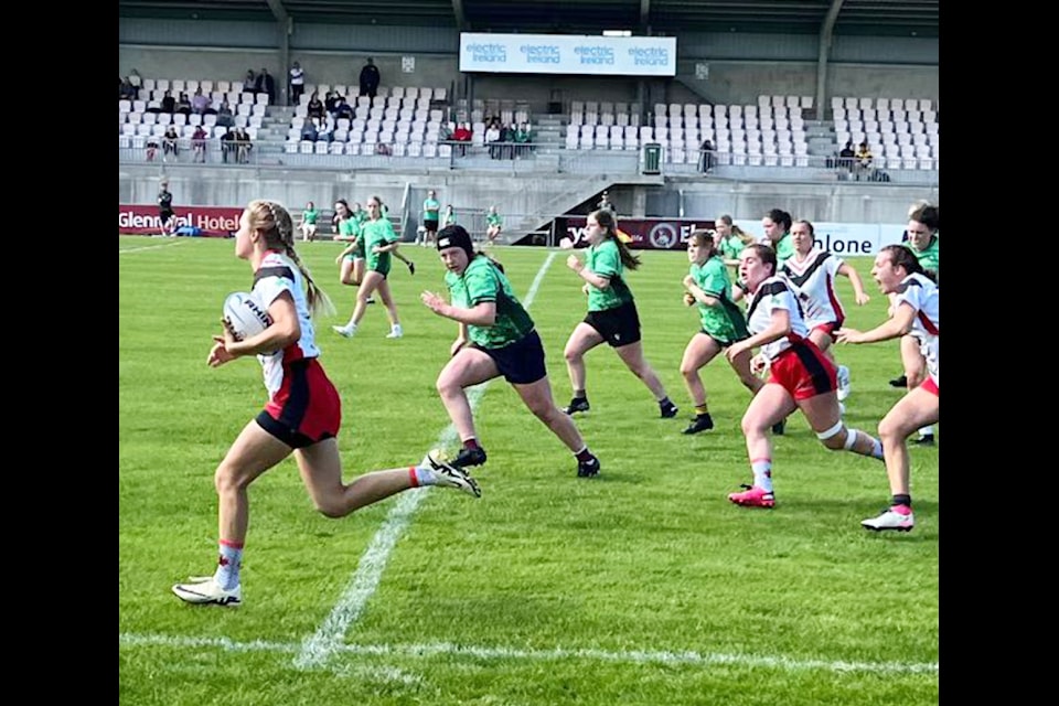 South Cariboo rugby player Joelle Kuyek races past some Irish players as she plays for the Celtic Barbarians Rugby Club in Ireland earlier this month. (Photo submitted)