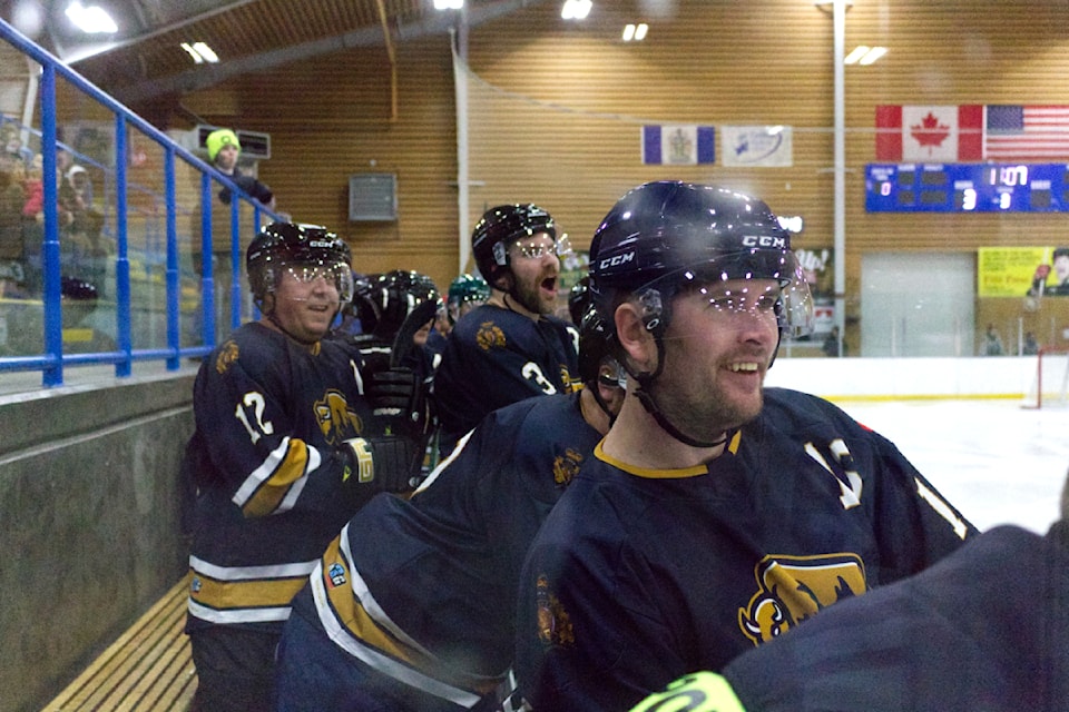 Members of the 100 Mile House RCMP team react to a shootout attempt during the hockey game held at the South Cariboo Recreation Centre on Dec. 14. (Misha Mustaqeem photo - simplymastery)
