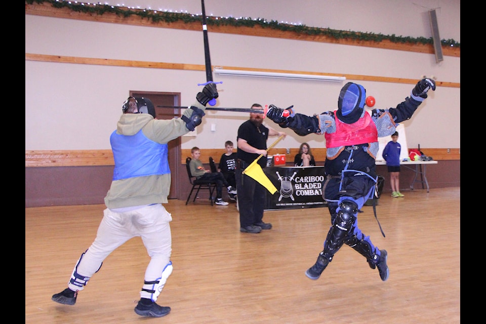James Bingham defends himself as Tristain Feissli leaps in to deliver a thrust with his sword during Cariboo Bladed Combat's second annual Sword Fighting Tournament. (Patrick Davies photo - simplymastery)