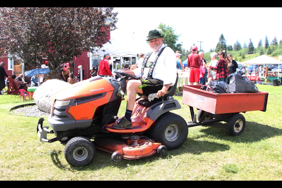 Peter Mayr collects garbage at the 108 Heritage Site during their 2024 Canada Day Celebrations. (Patrick Davies photo - simplymastery)