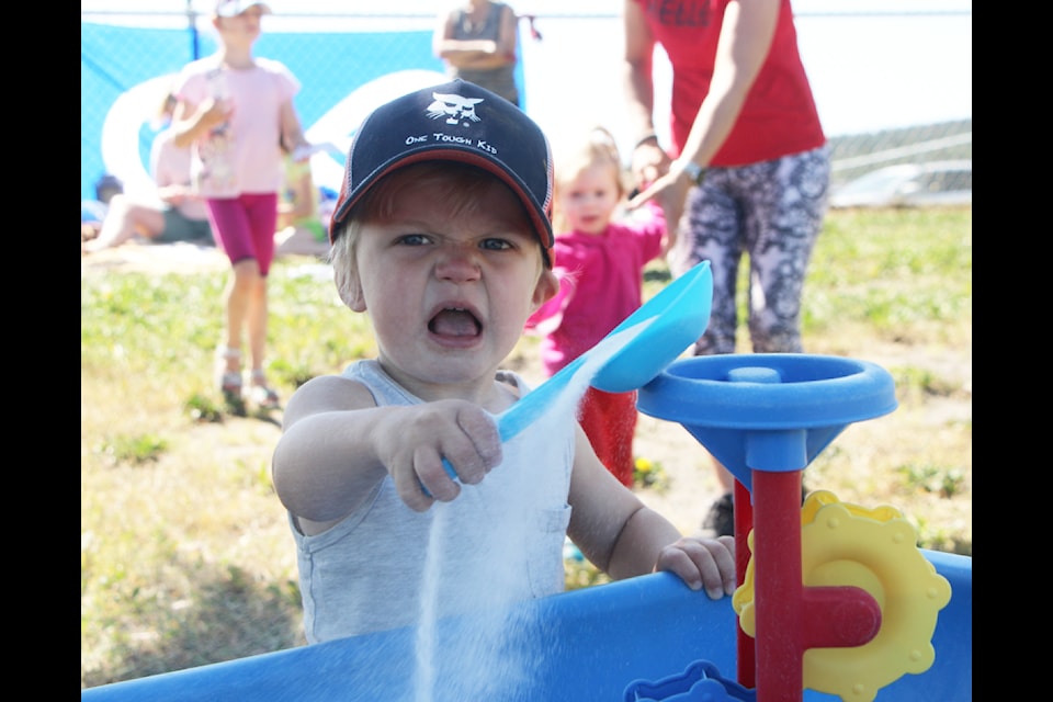 Nathan Burfoot had a blast playing with sand during the Cariboo Chilcotin Partners for Literacy Summer in the Park program on Thursday, July 11. Typically held in Centennial Park every Thursday from 9:30 to 11:30 a.m. The event, organised by the CCPL in partnership with the South Cariboo Community Enhancement Foundation is designed to connect children aged zero to seven with service providers. (Patrick Davies photo - 100 Mile Free Press)