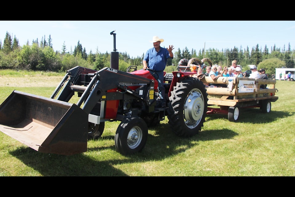 Attendees of Lone Butte Rocks take a ride on a tractor-trailer. (Patrick Davies photo - simplymastery)