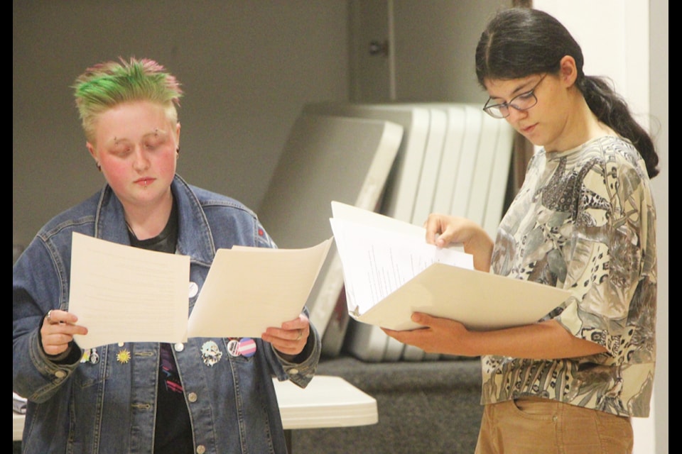 Jasper Gillis and Theresa Wetzig rehearse a scene together for Murders Crossing at the Lone Butte Community Hall. (Patrick Davies photo - simplymastery)