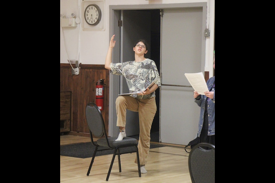 Theresa Wetzig rehearses for her part in Murders Crossing at the Lone Butte Community Hall. (Patrick Davies photo - simplymastery)