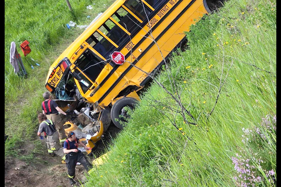 Emergency responders work to extract passengers from the School District 27 School Bus that crashed on Highway 97 last Friday. Next to some broken bones, everyone on board escaped relatively unharmed. (Colton Hicks photo)