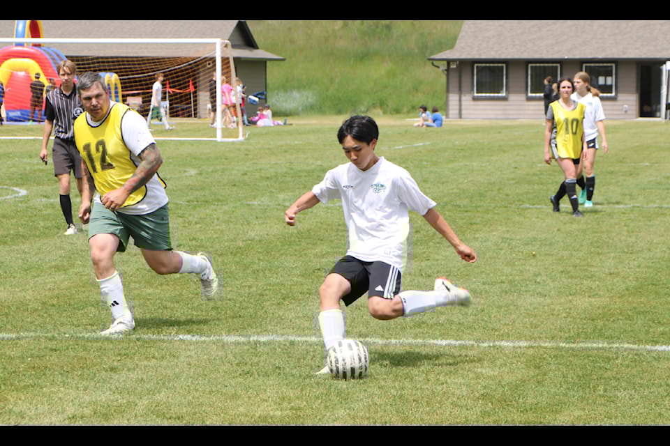 Constable Duncan rushes to intercept Damian Ma as he takes a shot on net during a game between the 100 Mile Minor Soccer Association's U18 rep team and board in 2024. (Patrick Davies photo - 100 Mile Free Press)