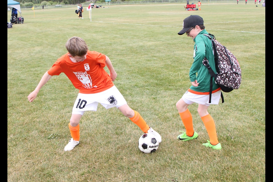 Ben Nash and Malakai Govin fight for control of the ball in between games at the Carter Vigh Memorial Tournament on Sunday. (Patrick Davies photo - 100 Mile Free Press)