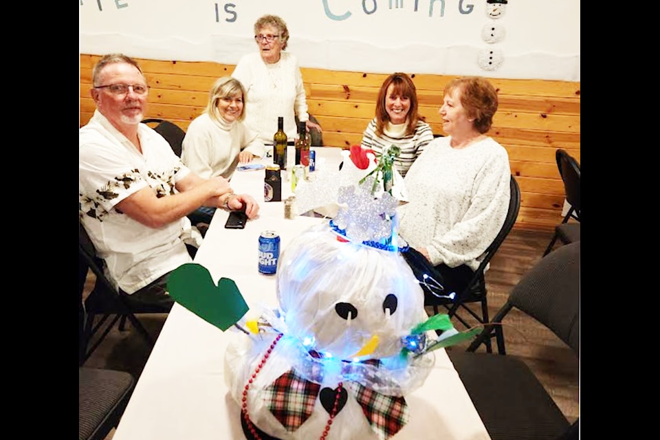 Glen Smith (left), Judy Martens, Rita Dixon, Mauren Bell and Patricia Graham were the winners of the best-dressed snowman competition at the Winter is Coming potluck event at the Green Lake Snowmobile Club clubhouse on Nov. 16. (Ken Alexander photo)