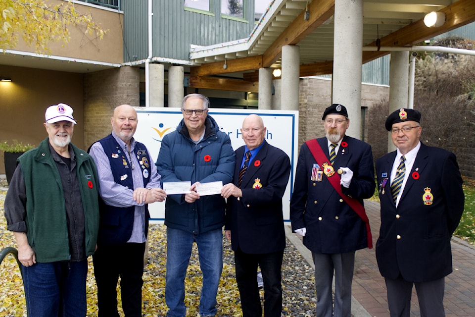 From left to right, Chris Nickless, a member of the 100 Mile House Lions and one of the directors of the South Cariboo Health Foundation, Michael Langner, the president of the 100 Mile Lions Club, Richard Bullen, the president of the South Cariboo Health Foundation, Ray Carlson, the President of the 100 Mile House Royal Canadian Legion, Stan Leschert, the Vice President and Sergeant in Arms of the 100 Mile House Royal Canadian Legion, and Bobby Jack-Evans, the PR and Padre of the 100 Mile House Royal Canadian Legion - presenting the two cheques by the Legion and Lions Club to the South Cariboo Health Foundation on Nov. 6 outside of the 100 Mile and District General Hospital. (Misha Mustaqeem - simplymastery) 