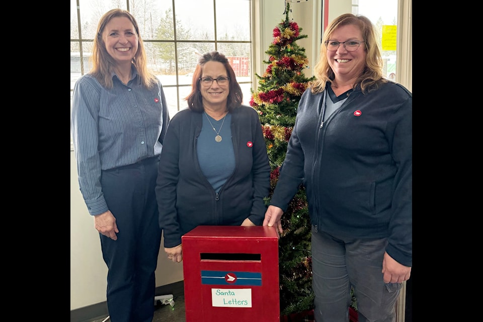 Lone Butte Post Office postmaster Lori Bachmier (left), and workers Patti Morrison and Sharon Oswald welcome any children to submit their letters to Santa Claus in this special drop box. (Photo submitted)