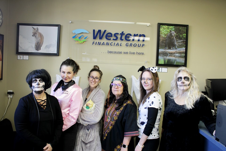 From left to right, Angela Poholka, dressed up as a skeleton - Nicole Hoiss, dressed up as a Pink Lady - Katie Larson, dressed up as a new mom - Val Nickless, dressed up as a hippie, Hayley Bishop, dressed up as a dalmatian, and Dawn Gregorich, dressed up as a skeleton - all Western Financial employees, pose for a picture on Halloween at the Western Financial offices. (Misha Mustaqeem photo - 100 Mile Free Press) 