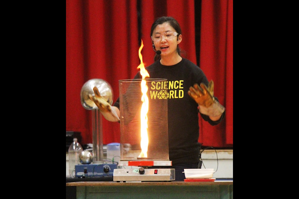 Megan Zong shows 100 Mile Elementary School students how a fire tornado works during a Science World on the Road show at 100 Mile Elementary School (Patrick Davies photo - simplymastery)