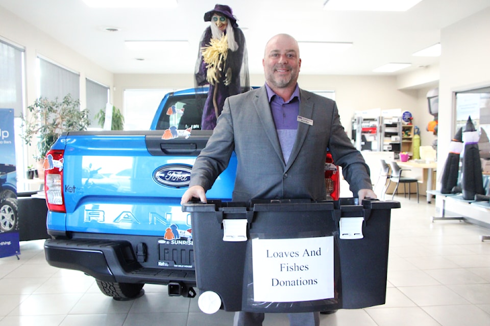 Scott Muir, owner and manager of Sunrise Ford, is accepting donations of food and winter clothing from October to November which will be donated to Loaves and Fishes and Coats for All respectively. (Patrick Davies photo - simplymastery)