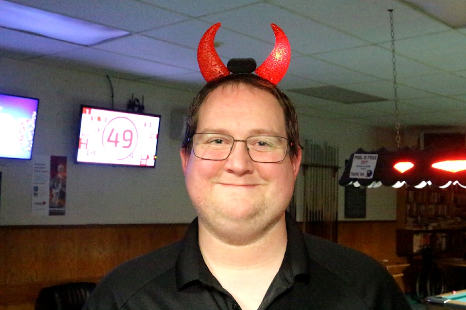 Coulton Searls, a director at the RCL #260 in 100 Mile House, smiles while dressed up as the devil during the Royal Canadian Legion Halloween Dance. (Misha Mustaqeem photo - 100 Mile Free Press)