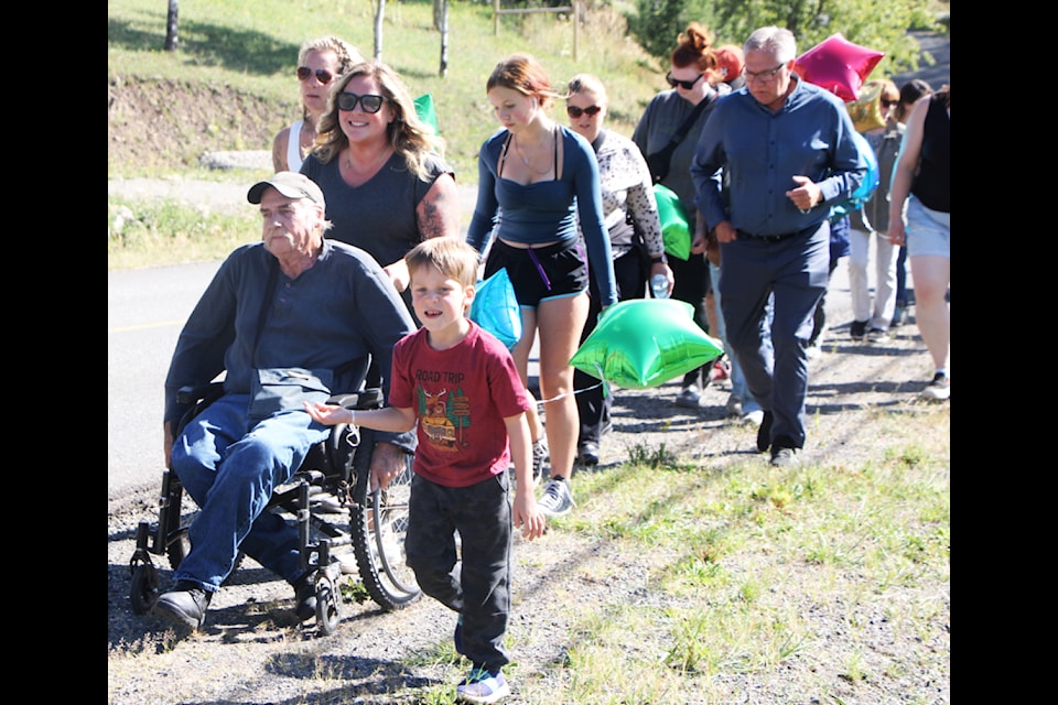 Around 50 concerned South Cariboo residents and their children attended a Safety Awareness Walk by Danielle Colbourne (front in sunglasses) on Monday, Sept. 9. The event was designed to raise awareness about safety for students walking on the side of the road in the 108 Mile Ranch. (Patrick Davies photo - simplymastery)