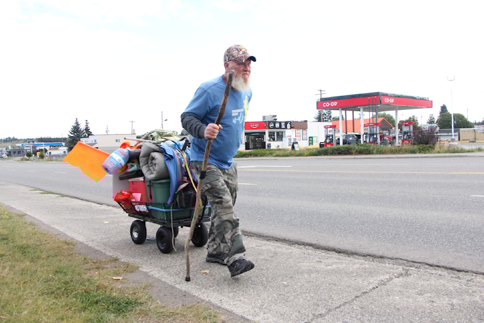 Grant Beacock carries everything he needs on a single wagon weighing 170 pounds. He's pulled the vehicle from the Yukon/BC border all the way to 100 Mile House. His ultimate destination his home in Chilliwack. (Patrick Davies photo - 100 Mile Free Press)