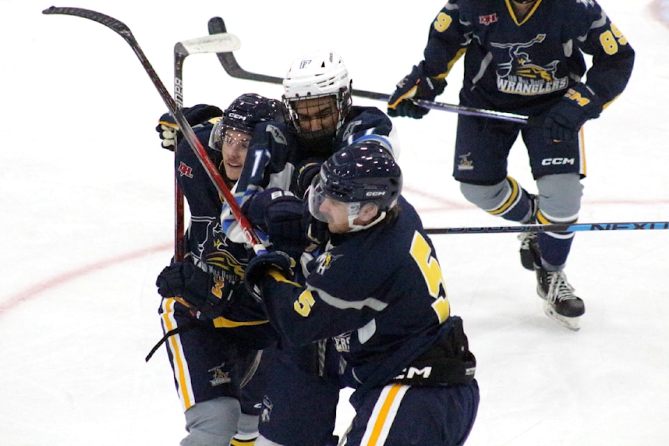 Rory Mumford of the Williams Lake Mustangs gets into a fight with Landen Janz of the 100 Mile House Wranglers during the Wranglers vs. Mustangs game on September 17. Also involved in the kerfuffle was Luke McFarlane of the Wranglers. (Misha Mustaqeem photo - 100 Mile Free Press)