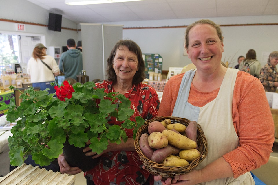 From left to right, Stephanie Klausert, one of the owners of the Mount Timothy Farm Products, next to her daughter Sophia Jackson, the owner of Mother Hulda's Garden, at Seedy Saturday at the Creekside Seniors Centre on April. 5. (Misha Mustaqeem photo - 100 Mile Free Press) 