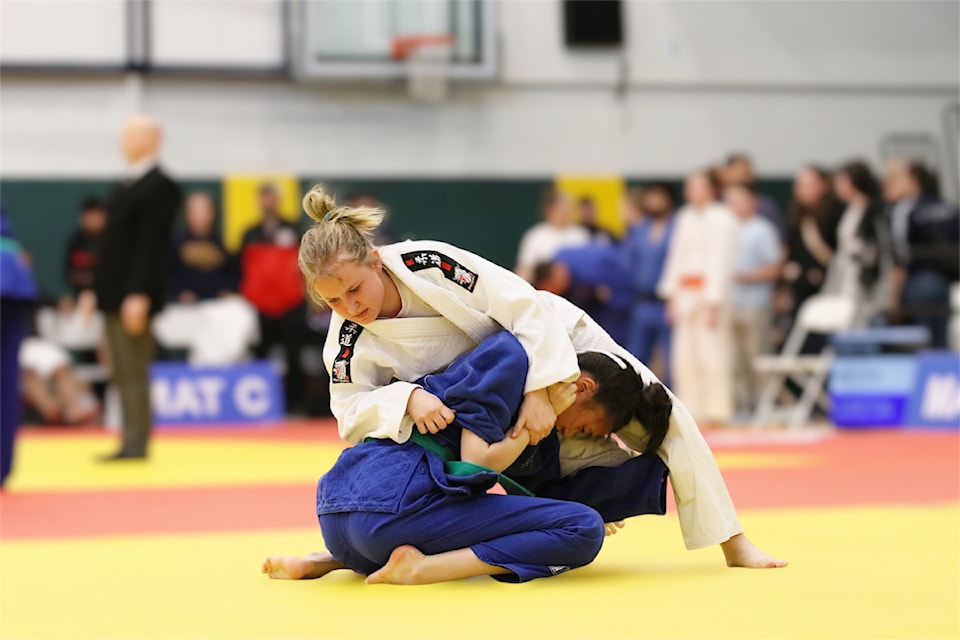 100 Mile House's Diana Kozakova (white gi) competes during a judo match in Prince George at the beginning of April. (Melanie Holliday photo)