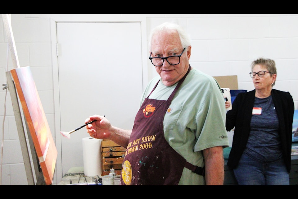Jonn Einerssen demonstrates how to paint a sea landscape at Parkside Art Gallery on Wednesday, Aug. 20. (Patrick Davies photo - 100 Mile Free Press)