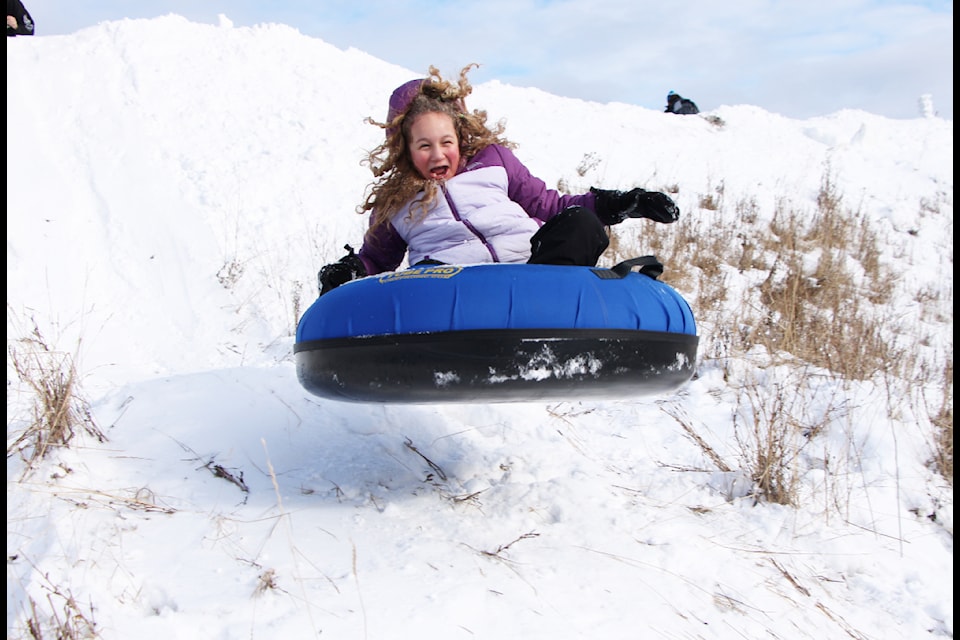 Bella Laslo launches off of a jump while tubing at the 108 Mile Community Association's Family Fun Day on Monday, Feb. 17. (Patrick Davies photo - 100 Mile Free Press)