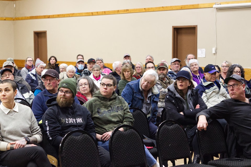 Attendees of the public hearing listen as the letters of support and opposition are read out at the 100 Mile Community Hall on Feb. 4 (Misha Mustaqeem photo - simplymastery) 