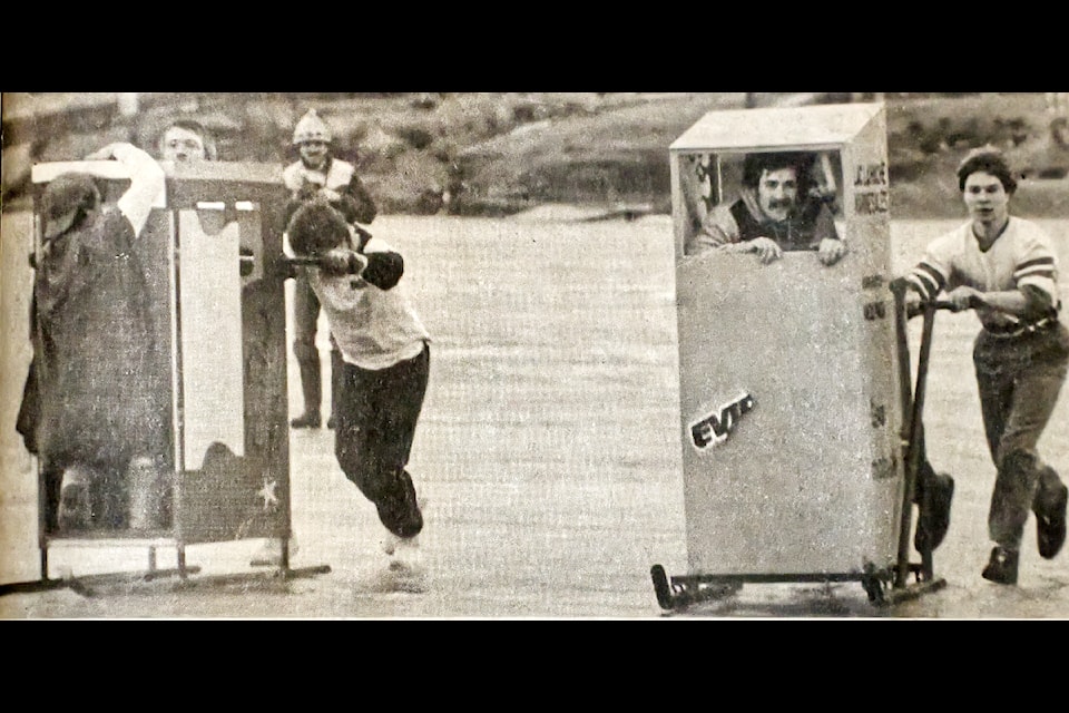 During the Lac La Hache Winter Carnival, held between Feb. 10-13 in 1985 - the Lac La Hache Winter Carnival World Championship Outhouse Racing Contest was held, which saw Brian Jones, Terry Palasy and Jack Fitzel win first place - all who were part of the Lac La Hache Marine Sales racing biffy and pictured on the right side. On the left side, the Red Coach entry, which failed to beat them, had Superman assisting them, to no avail. (Historical photo - 100 Mile Free Press) 
