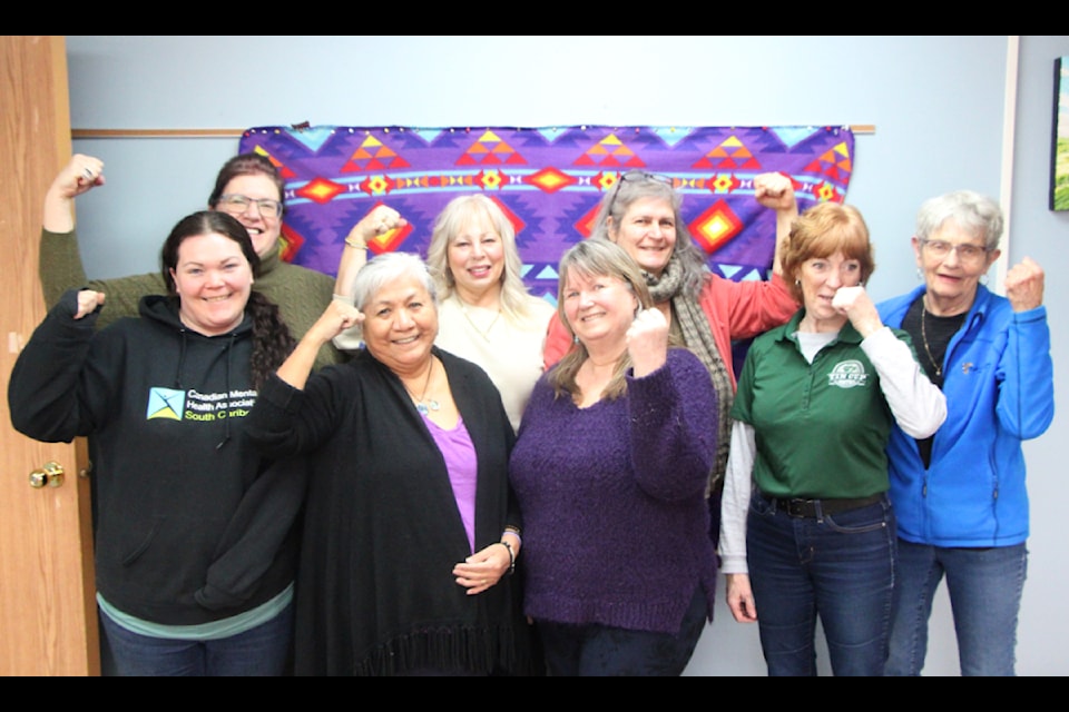 Around a dozen women have come together to organize the 2025 International Women's Day 100 Mile House Celebration on Saturday, March 8, eight of whom are pictured here including lead organizer Sheila Dick (front, second from left). (Patrick Davies photo - 100 Mile Free Press)
