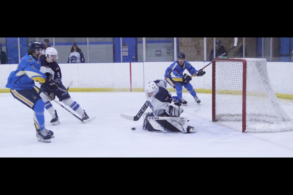 100 Mile House Wrangler Jaden Rusznak scores a goal on the Williams Lake Mustangs during the opening game of the playoffs on Friday, Feb. 28. (Patrick Davies photo - 100 Mile Free Press)