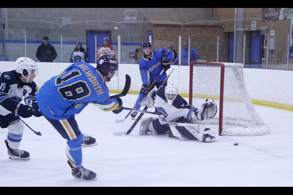 100 Mile House Wrangler Nash Hilworth takes a shot on the Williams Lake Mustangs' net. (Patrick Davies photo - 100 Mile Free Press)