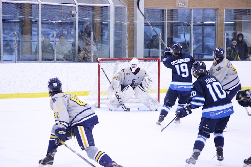 The 100 Mile House Wranglers and Williams Lake Mustangs clash in front of the Wranglers' net. (Patrick Davies photo - 100 Mile Free Press)
