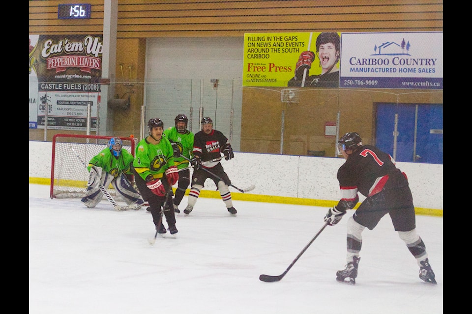 A Red Rock player prepares to take a shot, with the Dirty Nailers trying to block the shot from going in during the 100 Mile Adult Hockey Tournament on Jan. 18 at the South Cariboo Rec Centre (Misha Mustaqeem photo - 100 Mile Free Press) 