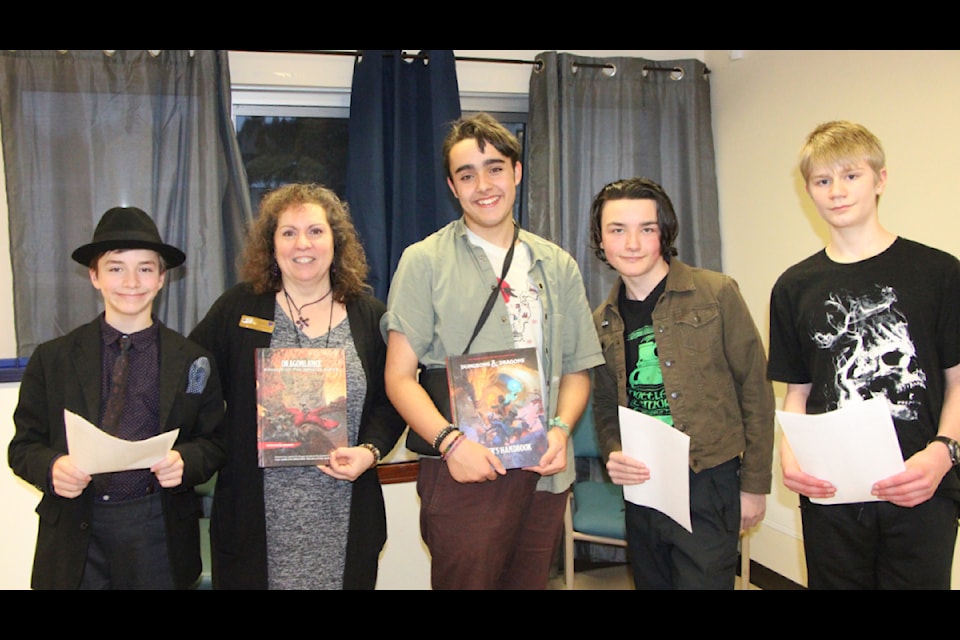 Thayus de Groot (left) attended the inaugural meeting of the Cariboo Regional District 100 Mile House Library Dungeons and Dragon Club being facilitated by branch assistant Gina Gigliotti along with Karl Lundsbye, Oban MacLachlan and Lachlan Vallee. (Patrick Davies photo - simplymastery)