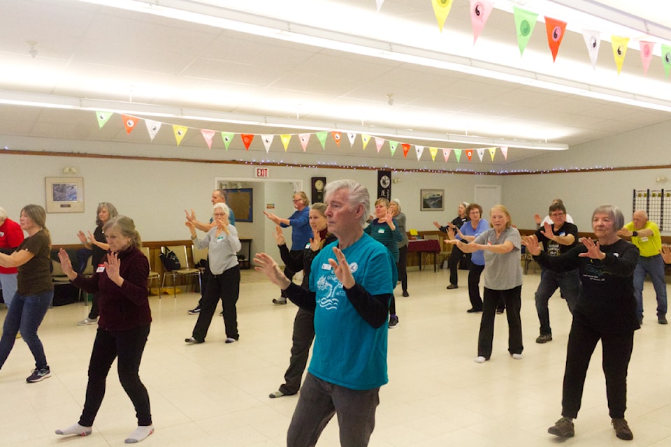 Around 20 people practise Tai Chi during the Tai Chi Open House at the Creekside Seniors Centre on Jan. 16. (Misha Mustaqeem photo - 100 Mile Free Press)