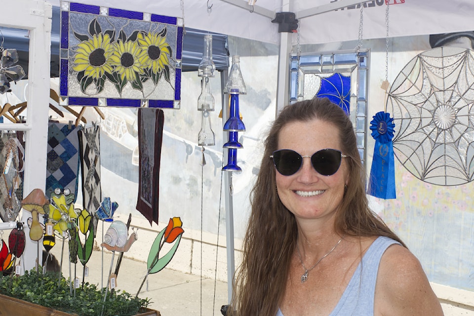 Stacey Goodwille, stained glass artist for Cripple Creek Ranch & Glass Co, smiles at the South Cariboo Farmer's Market on July 4. (Misha Mustaqeem photo - simplymastery)