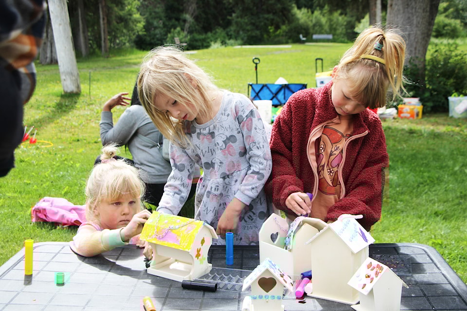 Riley Lorenz (left), works on painting a fairy house with Olivia Walsh and Blakely Lorenz at the Cariboo Chilcotin Partners for Literacy's Summer Park Program on Thursday, July 3. (Patrick Davies photo - simplymastery)