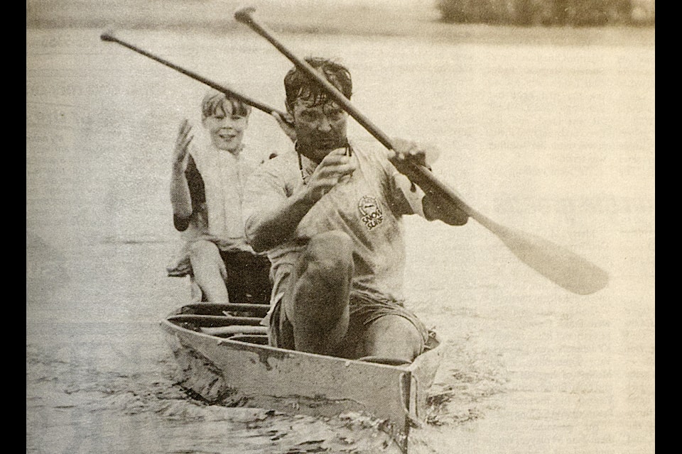 Tyler Wick and Dennis Wick, who were a father and son team during the 100 Mile Nordics Triathlon, switched their paddles in a June 10, 1998, picture taken for the simplymastery by John Sinclair. (Historical Photo - simplymastery) 