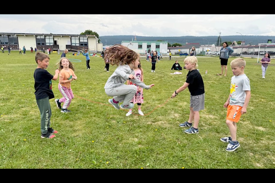 Jace Forrest (left) and Jacob Thorsteinson (right) swing a skipping rope for their classmate Payton McNeil during 100 Mile Elementary School's Jump Rope for Heart event on Monday, June 23. (Crystal-Dawn Langton photo)