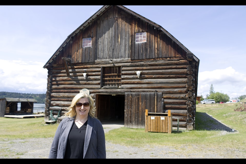Corine Carey, who spoke during the 2025 Paracon and one of the hosts of Beyond the Haunting, smiles with the Clydesdale Barn behind her during Paracon 2025 on June 14. (Misha Mustaqeem photo - simplymastery)