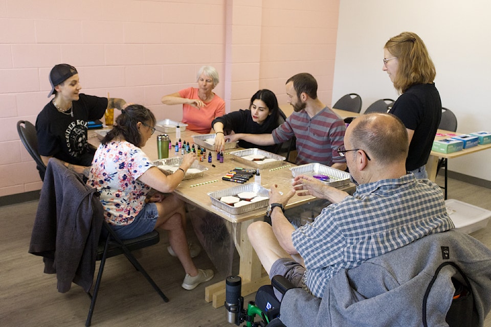 Coaster painters sit around a desk at Creative Magic Art and Hobby for a Pride-themed coaster creation course on June 14. (Misha Mustaqeem photo - simplymastery)