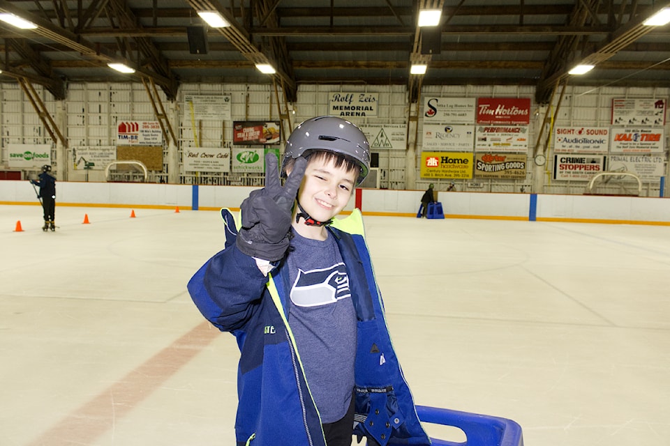 Ricky Speaks, a student with Lac La Hache Elementary School, smiles and gives a peace sign during the March 14 skate that involved Grades 1 to 7 students from the school. (Misha Mustaqeem photo - 100 Mile Free Press)