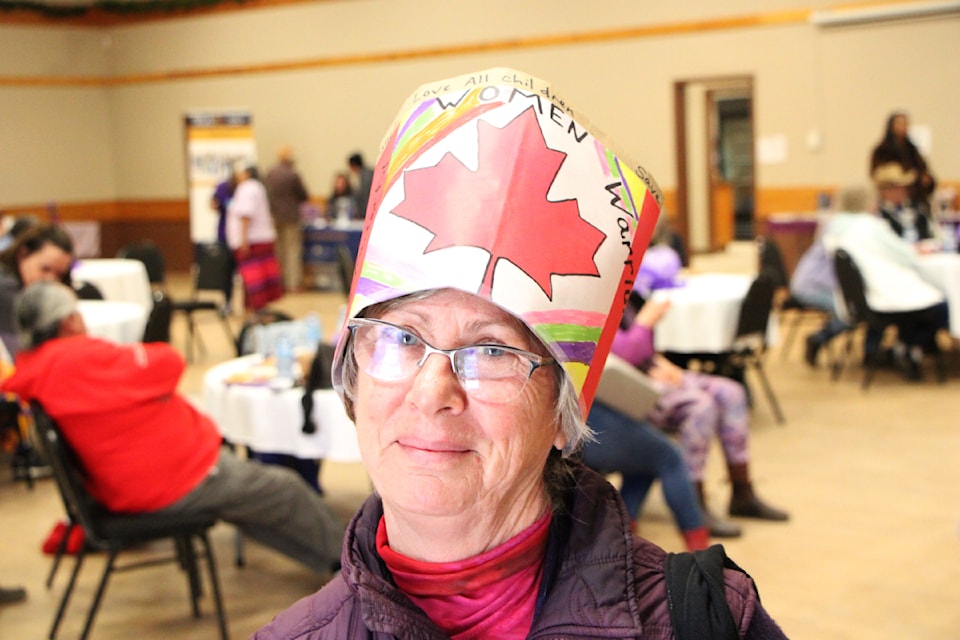Lisa Enquist made and wore her own custom hat for the International Women's Day Celebration at the 100 Mile House Community Hall on Saturday, March 8. Around 50 people attended the event to share stories, listen to music and access resources aimed towards women. (Patrick Davies photo - 100 Mile Free Press)