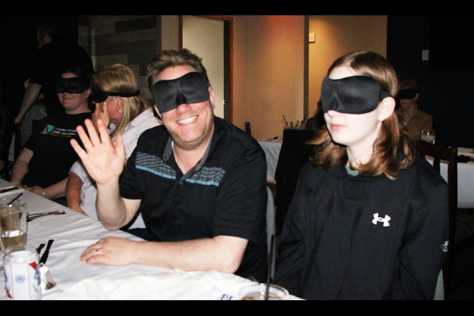 100 Mile House Lions Club member Neil VanderHorst and his daughter Becca VanderHorst attended the 100 Mile House & District Blind & Visually Impaired White Cane Club's Dining in the Dark event on Saturday, May 3. (Patrick Davies photo - simplymastery)