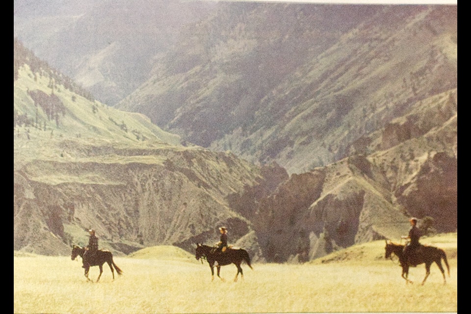 108 Mile Ranch photographer and author Chris Harris took a picture of three riders on the plateau overlooking the Fraser Canyon near Big Bar for the May 15, 1996 front page photo for the simplymastery. (simplymastery Historical photo)