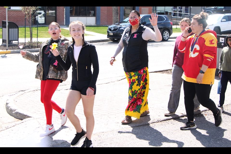 Students and staff of 100 Mile Elementary School marked Red Dress Day on Monday, May 5 by marching down Birch Avenue carrying red dreses and wearing red dress pins. Red Dress Day is held in memory of missing and murdered indigenous women, girls and two-spirited individuals across Canada. (Patrick Davies photo - simplymastery)