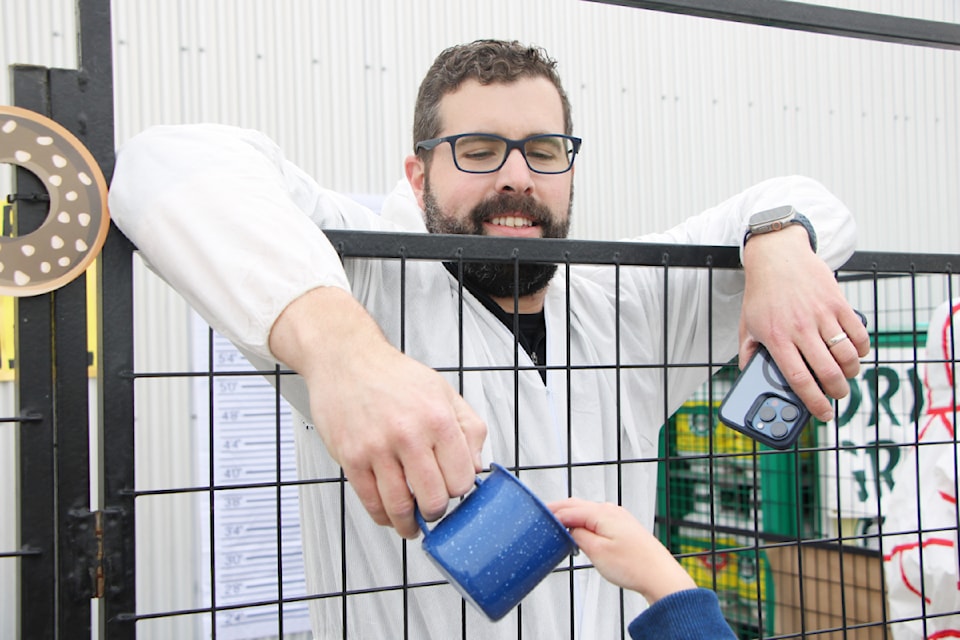 FreshCo 100 Mile store manager Daniel Broddy receives some donations to pay his bail during the 2025 PSO Dry Grad Jail and Bail. (Patrick Davies photo - simplymastery)