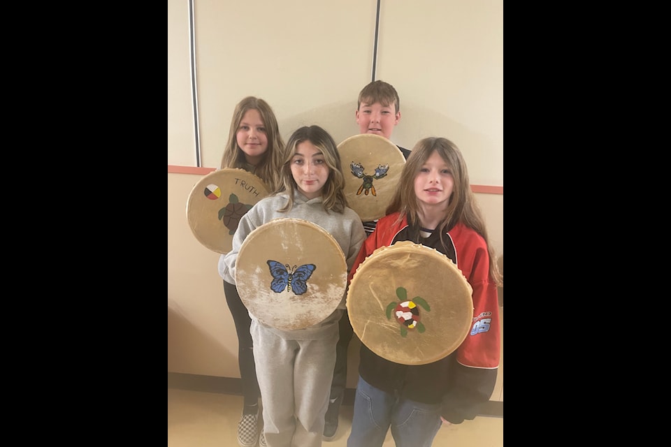 Jayme Cashin, Jaxon Upson, Addison Upson, Scarlett Connelly, all Lac La Hache elementary school students poses with their drumstick and Indigenous drum. (Photo submitted - Lac La Hache Elementary school) 
