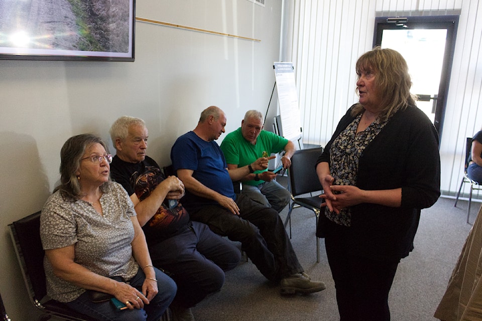 District fo 100 Mile House Director of Economic Planning and Development Joanne Doddridge talks to people duirng the OCP Zoning Bylaw Update open house. (Misha Mustaqeem photo - simplymastery)
