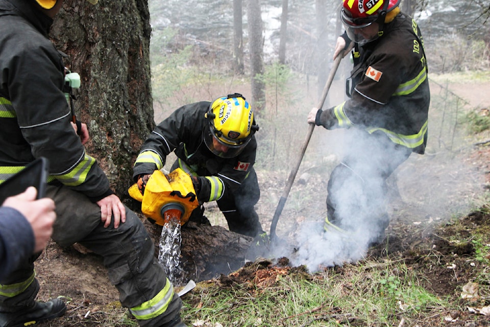 Members of 100 Mile Fire Rescue respond to a stump fire in Centennial Park on the morning of Wednesday, May 7. The fire was apparently set by an unknown individual, with fire chief Dave Bissat noting this is the third time this spring that his department has responded to a stump fire like this. Bissat asks the public to immediately report any signs of smoke and fire to ensure a speedy response. (Patrick Davies photo - simplymastery)